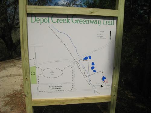 Map of Depot Creek Greenway Trail, showing paths, parks, and landmarks in the area of Downtown Lousdelle.