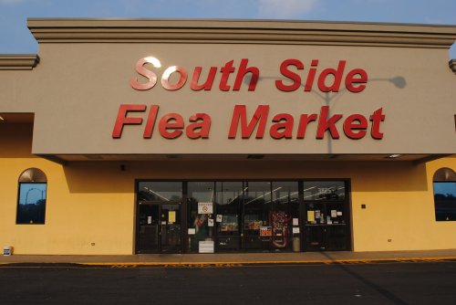 Exterior of the South Side Flea Market, featuring large red letters on a beige building with windows.
