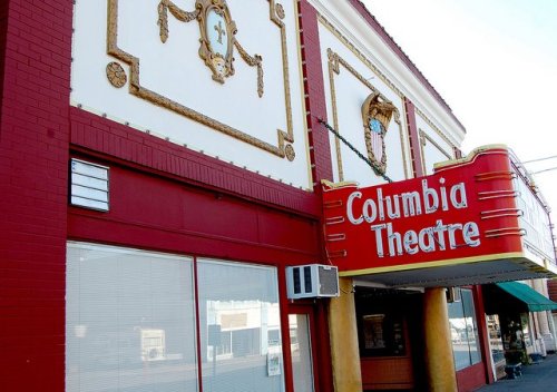 Exterior of the Columbia Theatre featuring ornate red and gold detailing and a prominent marquee sign.