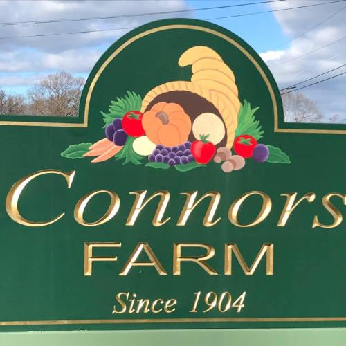 Sign for Connors Farm, featuring a cornucopia and the text "Since 1904" against a green background.