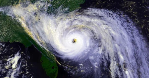 Satellite image of a powerful hurricane swirling over the southeastern United States, with clouds and ocean visible.