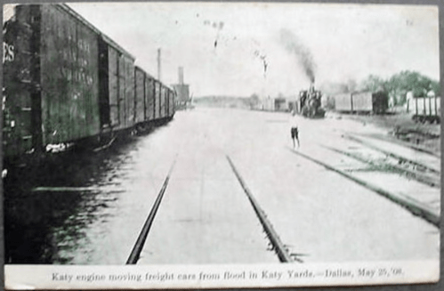 A vintage photo of a train engine moving freight cars in Katy Yards, Dallas, dated May 26, 1908.