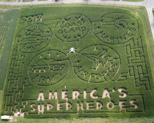 Aerial view of a corn maze featuring designs of superheroes and the text "America's Superheroes."