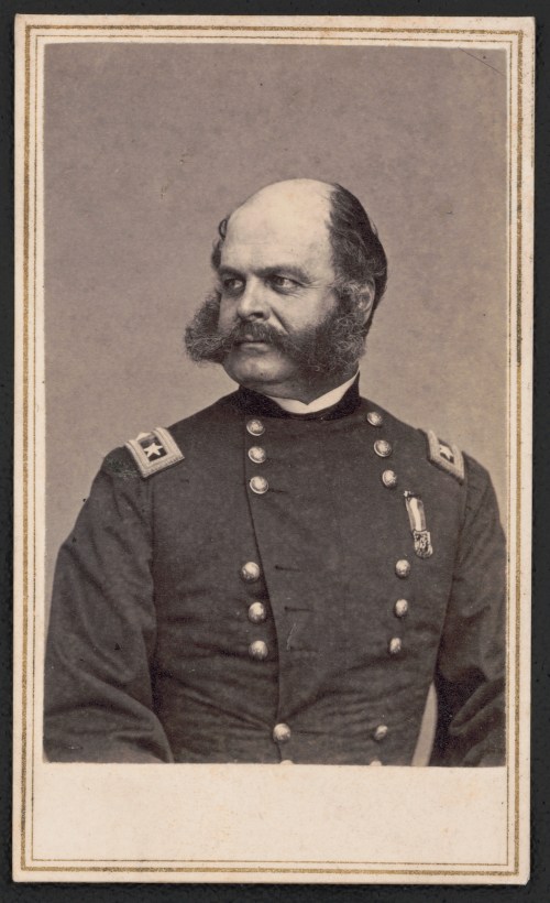 A historical portrait of a man in a military uniform with a prominent mustache and sideburns, looking to the side.