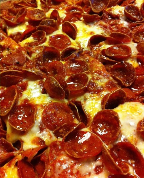 Close-up of a pepperoni pizza with melted cheese and a rich tomato sauce.