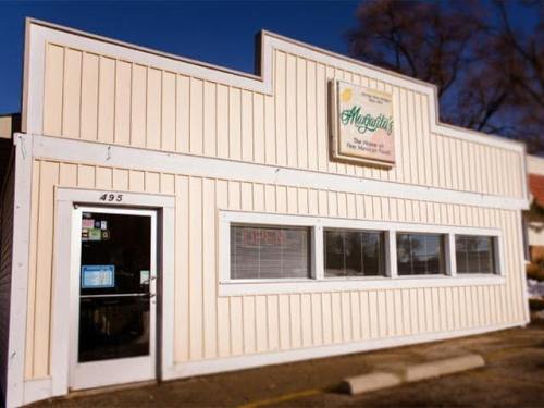 Exterior of a light-colored restaurant with a sign reading "Margarita's" and an "Open" sign in the window.