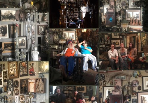 A cozy, eclectic room filled with vintage decor, framed photos, and three people sitting together, enjoying each other's company.