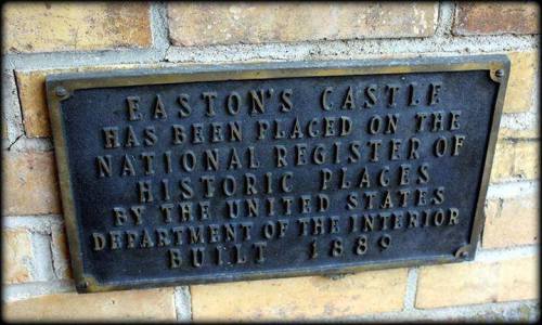 Plaque on a brick wall stating Easton's Castle is on the National Register of Historic Places, built in 1889.