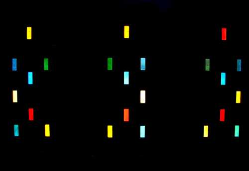 Colorful vertical bars of light against a dark background, creating a vibrant, abstract pattern.