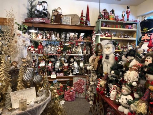 A festive display filled with Christmas decorations, including snowmen, trees, and various holiday ornaments.