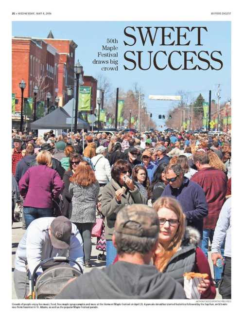 A large crowd gathers at the 50th Maple Festival, celebrating with food and festivities on a sunny day.