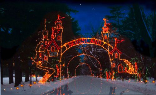 A festive archway of colorful lights reading "Skiessland" amidst a snowy landscape at night.