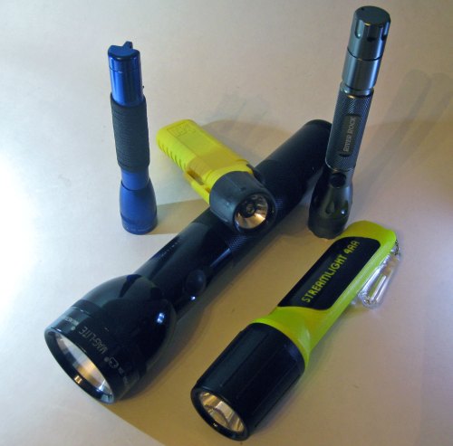 A collection of five flashlights in various sizes and colors, including black, yellow, blue, and silver.
