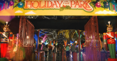 Entrance to "Holiday in the Park" with colorful lights and festive decorations, featuring nutcracker statues.