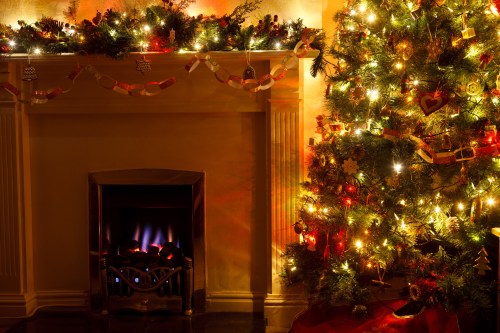 A cozy room with a decorated Christmas tree and a glowing fireplace, adorned with festive lights and ornaments.