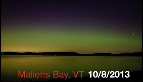 A serene night view of Malletts Bay, VT, showcasing the Northern Lights on October 8, 2013.