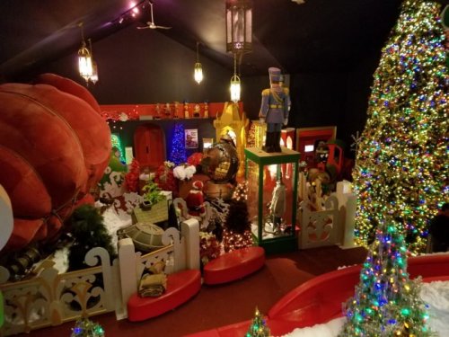 A festive holiday scene featuring a decorated tree, colorful lights, and a cozy room with Christmas decorations.