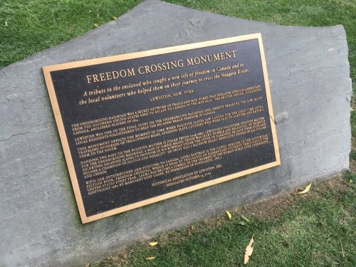 Plaque at Freedom Crossing Monument in Lewiston, NY, honoring those who aided enslaved individuals seeking freedom.