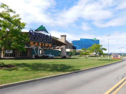 Exterior view of Seneca Allegany Casino with green landscaping and a blue sky in the background.