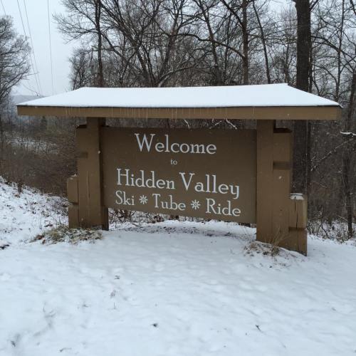Sign welcoming visitors to Hidden Valley Ski Tube Ride, surrounded by snow-covered trees.