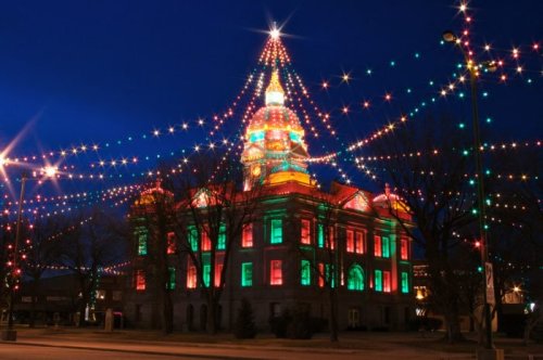 A beautifully lit building adorned with colorful Christmas lights, resembling a festive tree at night.
