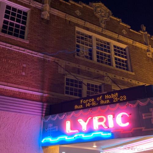 The Lyric Theater marquee at night, displaying "Force of Habit" show dates: Aug. 14-16, Aug. 21-23.