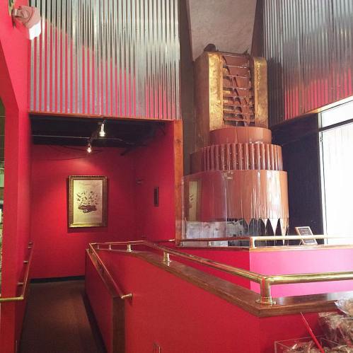 Interior of a modern space with red walls, a staircase, and decorative elements, creating a vibrant atmosphere.