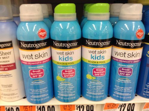 Three bottles of Neutrogena Wet Skin sunscreen for kids, featuring SPF 70 and SPF 85, displayed on a store shelf.