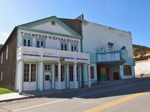 Historic buildings, Thompson's Opera House and Gem Theater, stand side by side in a small town.