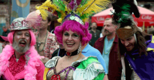A vibrant group of people in colorful costumes and elaborate headdresses, celebrating with joy and laughter.