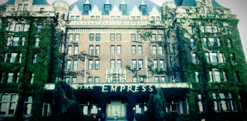 Historic hotel facade covered in ivy, featuring the name "The Empress" prominently displayed.