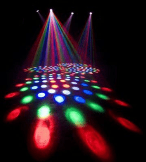 Colorful stage lights create a vibrant pattern on the floor, with beams of red, green, and blue illuminating the space.