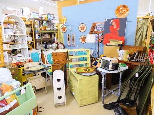 A cozy vintage shop filled with eclectic furniture, decor, and collectibles, showcasing a charming, cluttered atmosphere.