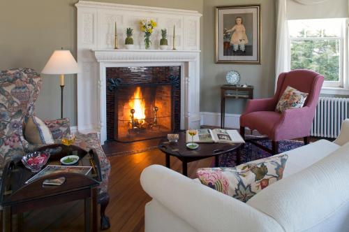Cozy living room with a fireplace, comfortable seating, and decorative accents, creating a warm, inviting atmosphere.