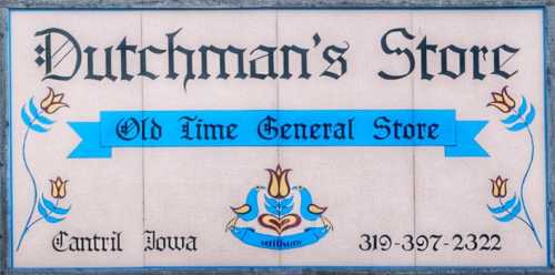 Sign for Dutchman's Store, an old-time general store in Cantril, Iowa, featuring decorative blue and yellow elements.