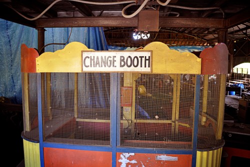 An old change booth with a colorful exterior, featuring a sign that reads "CHANGE BOOTH."