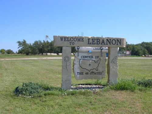 Welcome sign for Lebanon, featuring "Center of the 48 States" with a map outline and decorative elements.