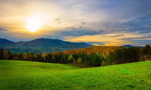 Sunrise over Vermont landscape with colorful fall foliage