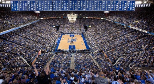 A packed basketball arena filled with fans, showcasing a vibrant atmosphere during a game.