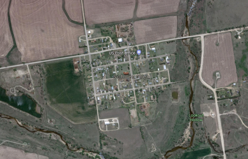 Aerial view of the small town of Schoenchen, Kansas, showing streets, homes, and surrounding farmland.