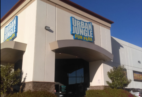 Exterior of Urban Jungle Fun Park, featuring a large sign and clear blue sky.