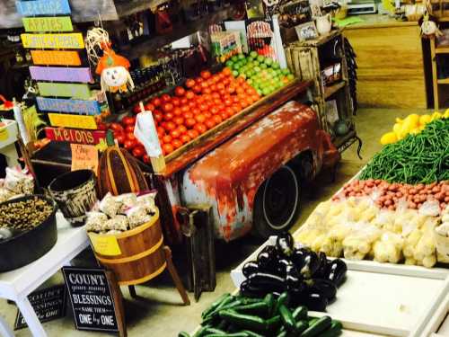 A vibrant market display featuring fresh vegetables and fruits, including tomatoes, melons, and green beans, in a rustic setting.