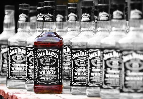 A collection of Jack Daniel's whiskey bottles, featuring a prominent bottle in the foreground.