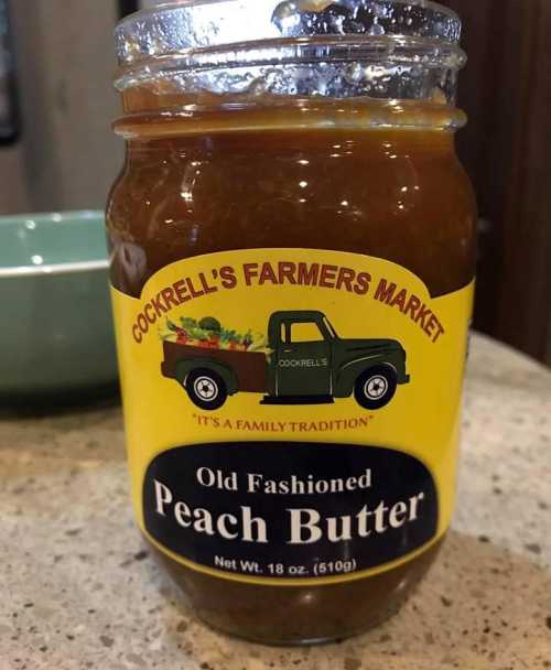 A jar of Old Fashioned Peach Butter from Cockrell's Farmers Market, featuring a vintage truck logo.