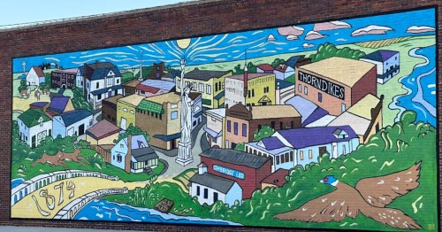 a colorful mural painted on a building wall in cambridge nebraska