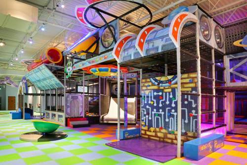 Colorful indoor play area with climbing structures, slides, and interactive features, designed for children's fun and exploration.