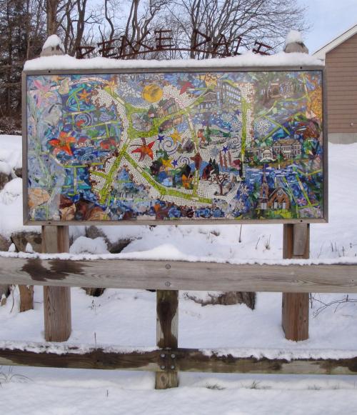 A colorful mosaic map displayed on a snowy landscape, showcasing various landmarks and features.