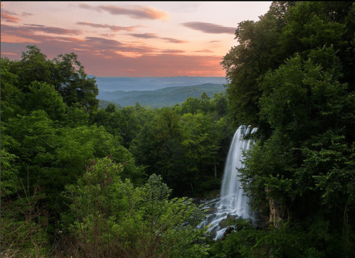 A serene waterfall cascades through lush green trees at sunset, with rolling hills in the background.