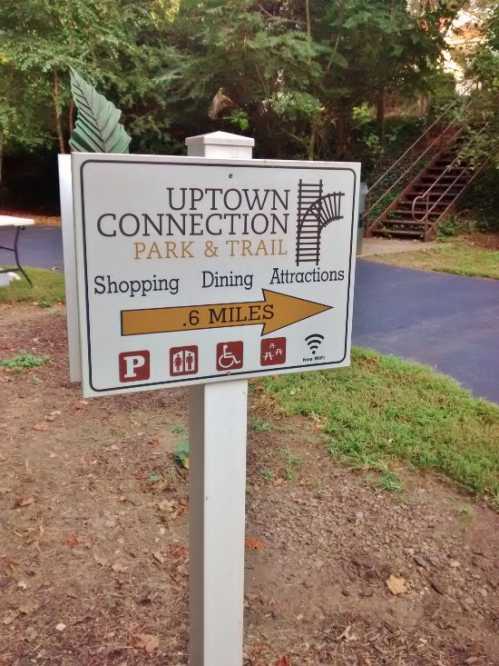 Sign for Uptown Connection Park & Trail, indicating shopping, dining, attractions, and distance of 0.6 miles.