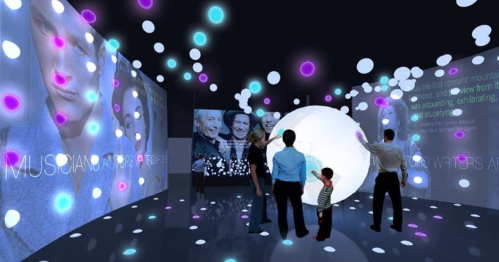 A digital art installation with colorful lights and projections, featuring people interacting with a large glowing sphere.